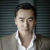 Man in suit with serious expression.