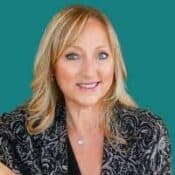 Smiling woman with blonde hair, teal background.