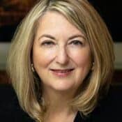 Portrait of a smiling woman with blonde hair.