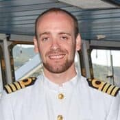 Ship captain smiling in control room.