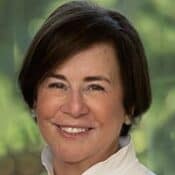Smiling woman with short dark hair.