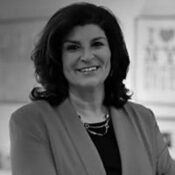 Smiling woman in professional attire, indoors.