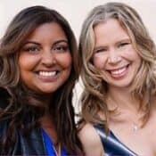 Two women smiling together, close-up portrait.