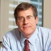 Man in glasses, wearing a suit and tie.
